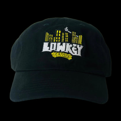 Black cap with embroidered text and graphics on a white background