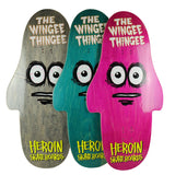 Heroin Skateboards The Wingee Thingee Deck 15.0 in grey, teal, and pink, with a unique cartoon face design.