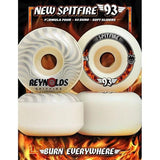 Spitfire F4 93 Radial Wheels Natural 56mm, four white skateboard wheels with Spitfire and Reynolds branding, on a fiery background.