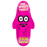 The Wingee Thingee Deck 15.0 by Heroin Skateboards. Pink skateboard with a cartoon face, wide eyes, and Wingee Thingee graphic.