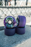 Close-up of four purple Slime Balls Kendall End of the World Reissue skateboard wheels with Jeff Kendall graphic